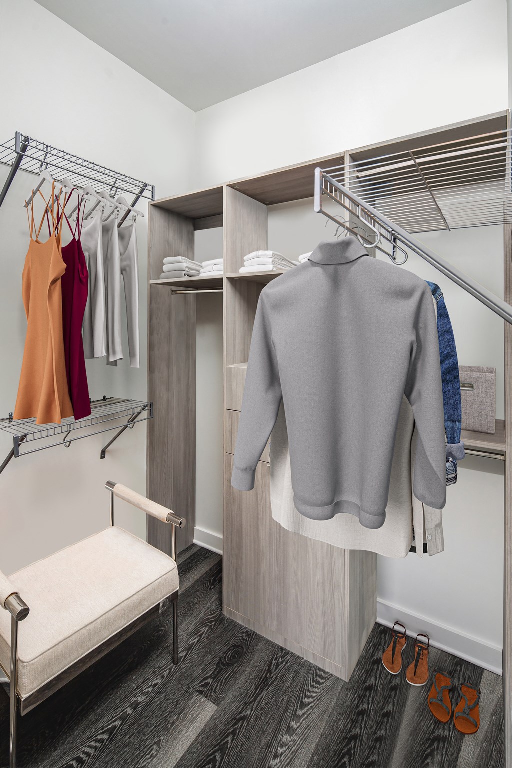 a spacious wardrobe with a bench and hangers a spacious wardrobe with a bench and hangers  at SLX Atlanta, Chamblee